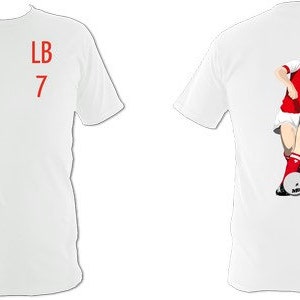 May include: White t-shirt with red text "LB 7" on the front. The back features a graphic of a footballer in a red and white kit kicking a football. The shirt is a classic crew neck style.