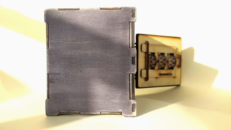 May include: A wooden box with a combination lock. The box is made of light brown wood and has a dark brown finish. The combination lock has three dials with numbers on them.