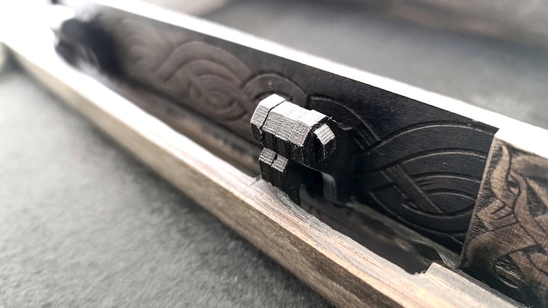 Side view of laser cut Celtic box showing corner details and side engraving.