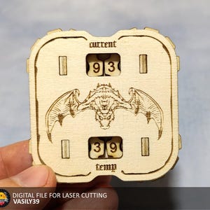 May include: A wooden laser cut panel featuring a dragon design. The panel has two digital displays, one labelled "current" and the other labelled "temp". The displays show the numbers 93 and 39.
