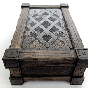 Close-up of engraved Celtic knotwork details on a laser cut wood box lid.