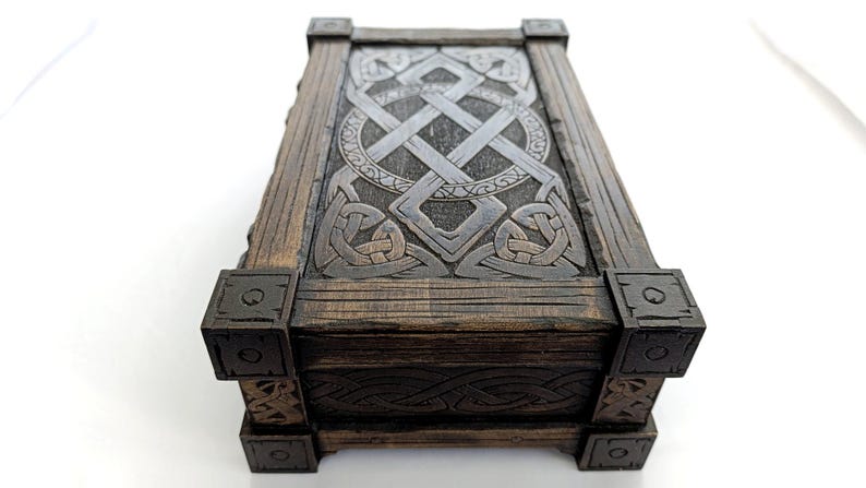 Close-up of engraved Celtic knotwork details on a laser cut wood box lid.