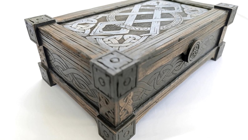 Assembled Celtic style storage box sitting on ancient stone surface.