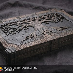 May include: A rectangular, intricately carved wooden box with a tree of life design on the lid. The box is a dark gray color with brown accents and features engraved runes. The text "DIGITAL FILE FOR LASER CUTTING" and "VASILY39" is visible.
