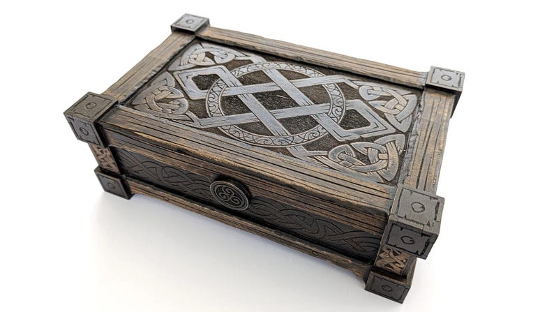 DIY laser cut project: Dark wood Celtic keepsake box with metal-look corners.