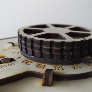 May include: A wooden box with a round dial and a sliding switch labelled "open" and "close". The dial has numbers from 1 to 20.