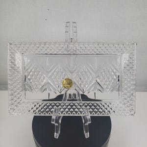 May include: A clear glass serving tray with a diamond pattern and a gold label that reads "Crystal Gallery".