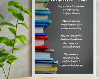 May include: A framed print with a homeschool prayer. The prayer is written in white text on a gray background. The print features a stack of colorful books.