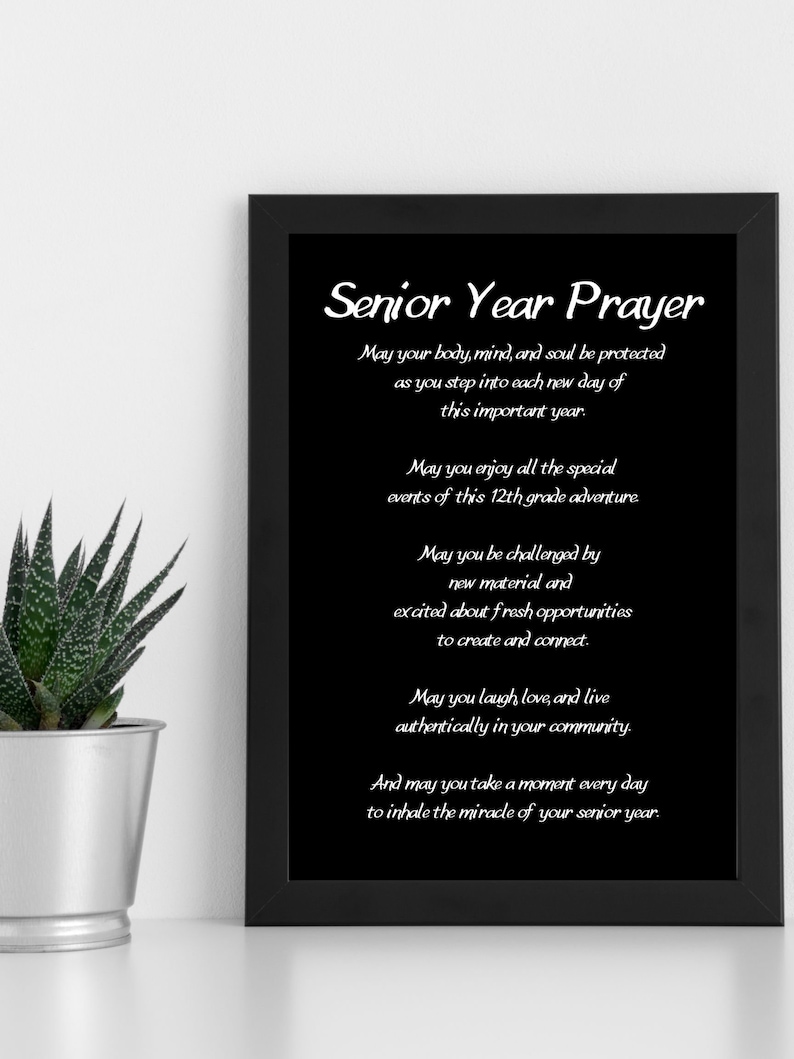 May include: A black framed print with a white background and the text "Senior Year Prayer" in a decorative font. The text continues with a prayer for a senior year filled with joy, challenges, and opportunities to connect with others.