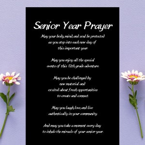 May include: A black card with white text that reads "Senior Year Prayer". The text is a prayer for a senior in high school, wishing them well in their final year. The card is surrounded by white flowers on a light purple background.