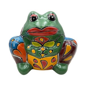 May include: A ceramic frog figurine with a glossy finish. The frog is primarily green with red lips, black eyes, and colorful patterns in blue, orange, yellow, and brown. The figurine has a whimsical, decorative design.