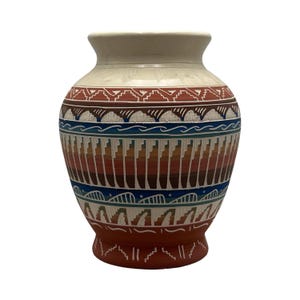May include: A ceramic vase featuring a cream-colored neck and a terracotta base. The body is decorated with horizontal bands of geometric patterns in shades of blue, white, brown, and orange, including stepped motifs and wavy lines.