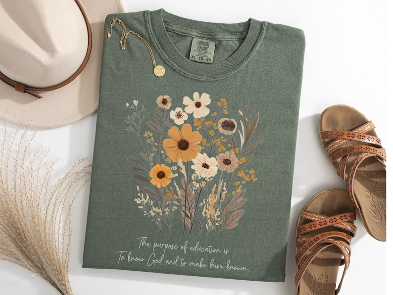 May include: A green t-shirt with a floral design and the text "The purpose of education is to know God and to make him known."