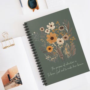 May include: A green spiral notebook with a floral design and the quote "The purpose of education is to know God and to make him known."