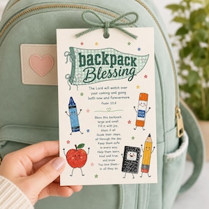May include: A rectangular white card with a green string bow at the top, featuring the text Backpack Blessing, Psalm 121:8, and a poem. The card includes colorful illustrations of a blue crayon, orange glue stick, red apple, black notebook, and yellow pencil.