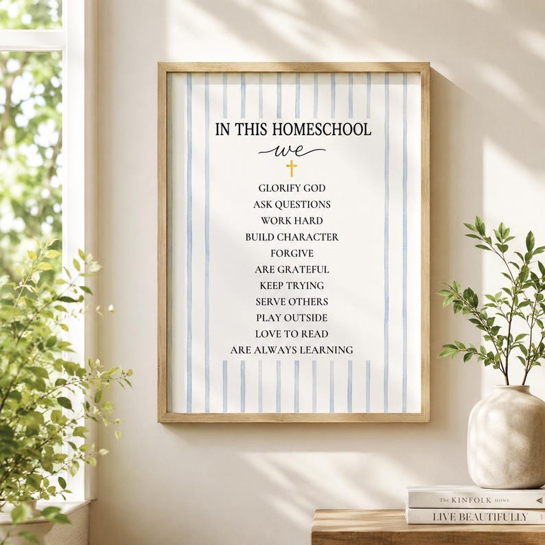 May include: A framed wall art print featuring a light blue vertical striped background and black text that reads: IN THIS HOMESCHOOL we, followed by a gold cross and a list of values including glorify God, ask questions, and are always learning.