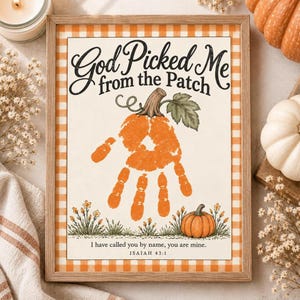 May include: A framed print featuring an orange handprint shaped like a pumpkin with a stem and leaf. The text reads God Picked Me from the Patch and I have called you by name, you are mine. ISAIAH 43:1. The border has an orange and white gingham pattern.