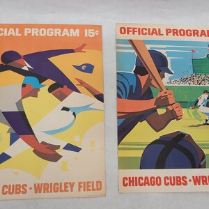 May include: Two vintage Chicago Cubs baseball game programs with colorful illustrations of players. The programs are titled "Official Program 15¢" and feature the team name and Wrigley Field.