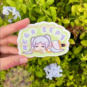 May include: A sticker featuring a cartoon character with white hair and a sleepy expression. The sticker has the text "ME GAE EEPY" in purple letters. The character is lying down on a light green background.