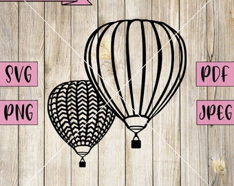 May include: Two black hot air balloons, one with a chevron pattern and the other with vertical stripes, against a woodgrain background.