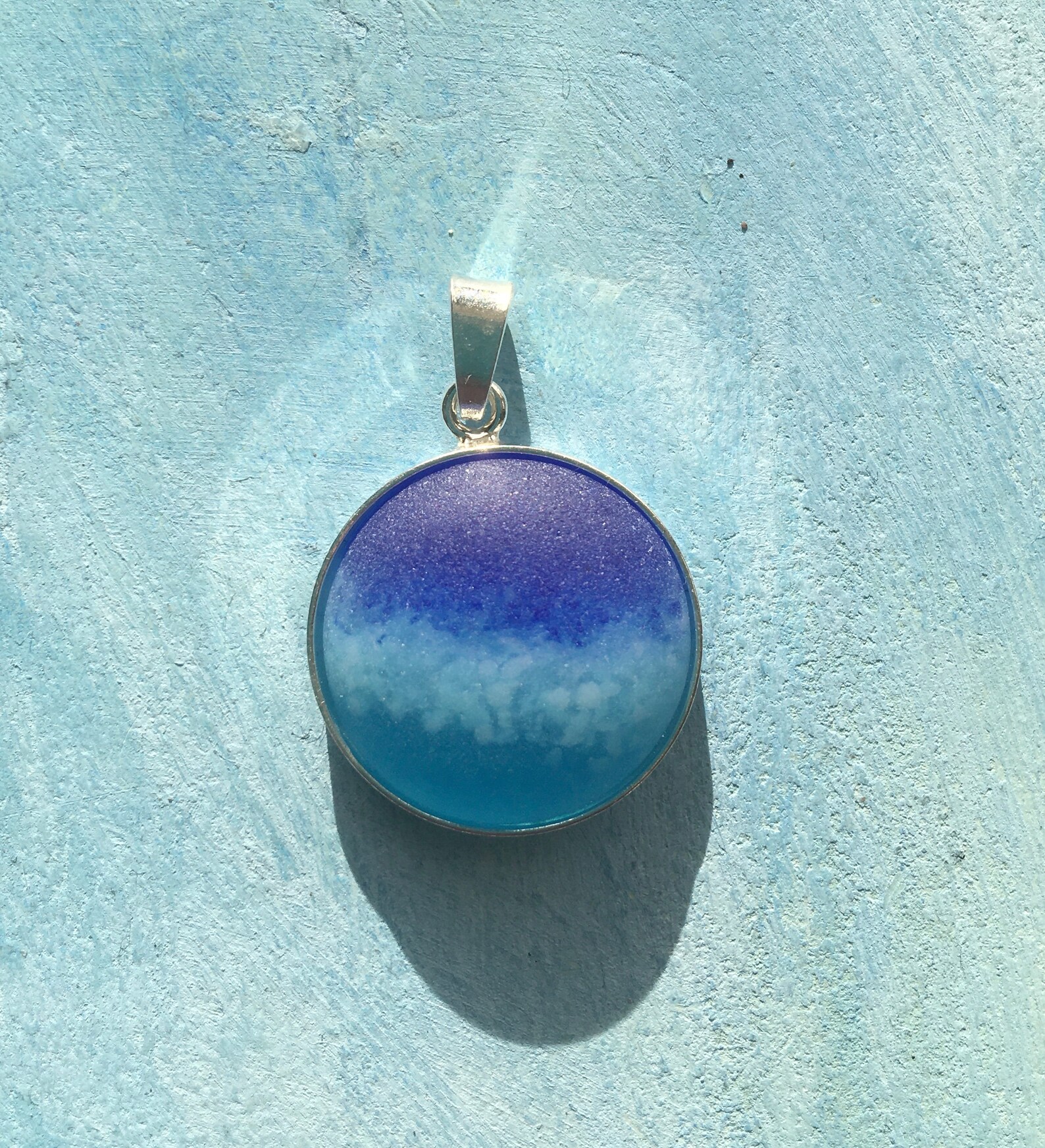 A Sea glass style pendant encased in a sterling silver wrap. Etsy