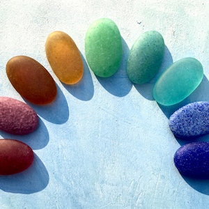 3 seaglass feel Memory pebbles encasing ashes, fur, hair, or sand. Individually made by hand.