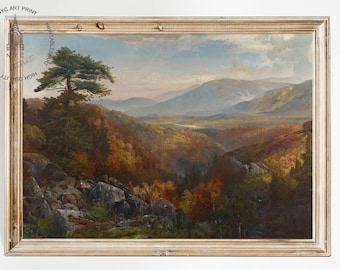 May include: A framed oil painting depicting a landscape scene with a valley surrounded by mountains and trees. The painting features a single tree in the foreground, with a rocky outcropping and a stream running through the valley. The sky is a light blue with some clouds.