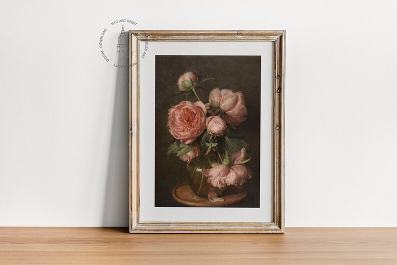 May include: A framed painting of a still life featuring a bouquet of pink peonies in a clear glass vase. The vase is sitting on a wooden table with a brown background.