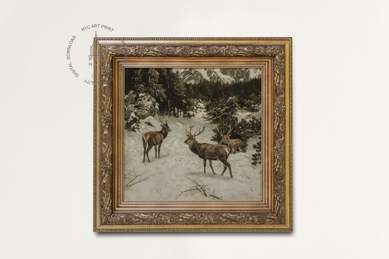 May include: A framed print depicting a winter scene with three deer in a snowy forest. The deer are brown with large antlers. The forest is dark green and the snow is white. The frame is gold and ornate.