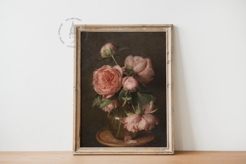 May include: A framed painting of a still life featuring a bouquet of pink peonies in a glass vase. The flowers are arranged in a vase on a wooden table. The background is a dark brown color.