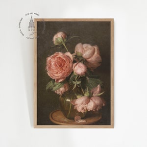 May include: A framed painting of a bouquet of pink peonies in a vase. The flowers are arranged in a vase on a wooden table. The background is a dark brown color.