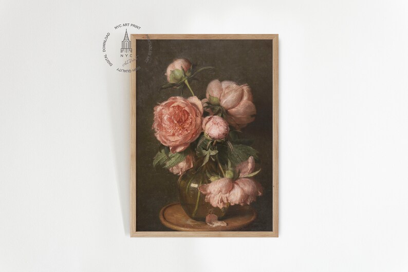 May include: A framed painting of a bouquet of pink peonies in a vase. The flowers are arranged in a vase on a wooden table. The background is a dark brown color.