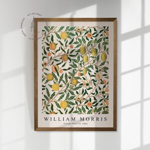 May include: A framed print of a vintage botanical illustration featuring a repeating pattern of green leaves, white flowers, and yellow and orange fruits. The print is titled "William Morris Four Fruits 1862".
