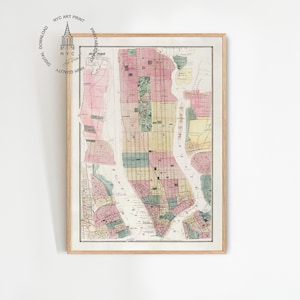 May include: Framed vintage map of New York City, featuring a detailed street layout with pink, green, and yellow color-coded areas. The map is enclosed in a light wooden frame, with the text "NYC ART PRINT" and a logo in the upper left corner.