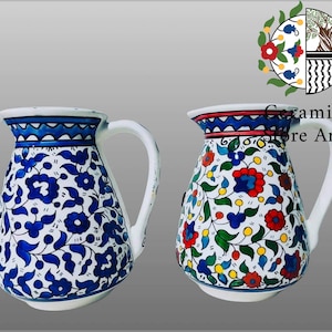 Könnte beinhalten: Zwei Keramikkrüge mit Blumenmustern. Der Krug links hat ein blaues und weißes Blumenmuster. Der Krug rechts hat ein mehrfarbiges Blumenmuster mit roten, gelben, blauen und grünen Akzenten.