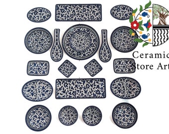 May include: A set of 17 ceramic plates and bowls with a blue and white floral pattern. The plates and bowls are arranged in a symmetrical pattern on a white background. The text "Ceramic Store Art" is visible in the upper right corner of the image.