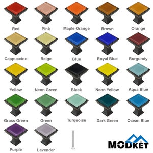 May include: A collection of square cabinet knobs in various colors, including red, pink, and blue. Each knob has a colored glass top and a dark metal base. The image includes the text "MODKET".