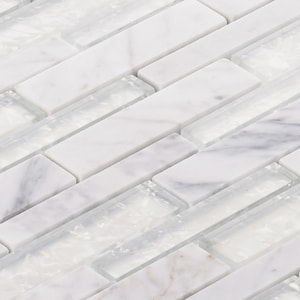 May include: Close-up of a mosaic tile pattern featuring rectangular pieces of white marble and translucent glass. The tiles are arranged in a staggered, linear pattern, creating a textured surface. The marble has subtle gray veining.