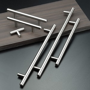 May include: A set of five stainless steel cabinet pulls in various sizes and styles. The pulls have a brushed finish and are designed for modern kitchens and bathrooms.
