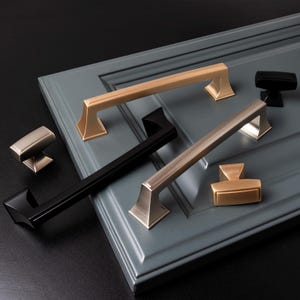May include: Assortment of cabinet hardware in black, brushed nickel, and gold finishes. The hardware includes pulls and knobs in various sizes and styles.