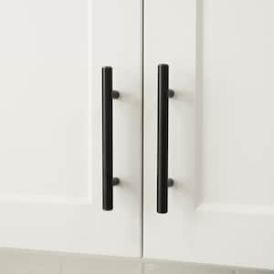 May include: Two black cabinet pulls with a copper finish. The pulls are rectangular in shape and have a simple, modern design.