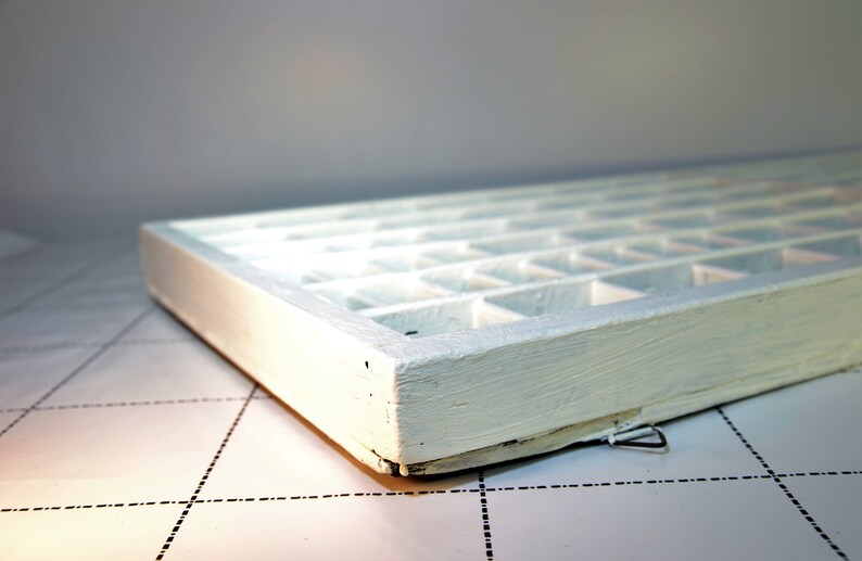 May include: White wooden box with multiple compartments. The box is empty and has a white painted finish.