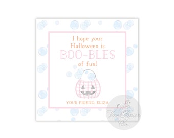 May include: A square gift tag featuring a light blue bubble pattern on a white background. The center contains a pink-bordered box with the text I hope your Halloween is BOO-BLES of fun! and a pink plaid jack-o'-lantern bucket, signed YOUR FRIEND, ELIZA.