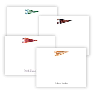May include: White notecards with pennant designs featuring college team names: Tulane, Auburn, Clemson, and Tennessee. Each pennant is in the team's colors. The names "Brooke Hughes" and "Katherine Harkins" are printed on two of the cards.