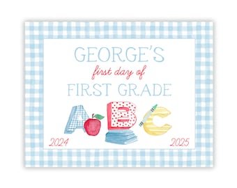 May include: A rectangular sign with a light blue gingham border featuring the text GEORGE'S first day of FIRST GRADE. Below the text are watercolor illustrations of the letters A, B, and C, a red apple, a stack of books, and the years 2024 and 2025.