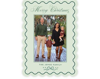 May include: A Christmas card with a family photo inside a light green scalloped border. The words "Merry Christmas" are at the top. The family is standing on a brick path. The family name and year are at the bottom.