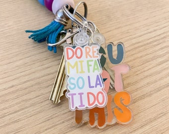 May include: A rainbow-coloured beaded keychain with a charm that says "You Got This" and features the musical notes "Do Re Mi Fa So La Ti Do".