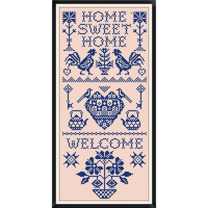 May include: A framed cross-stitch design with a pink background and blue embroidery. The design features the text "Home Sweet Home" with roosters, a heart, teapots, keys, and flowers.