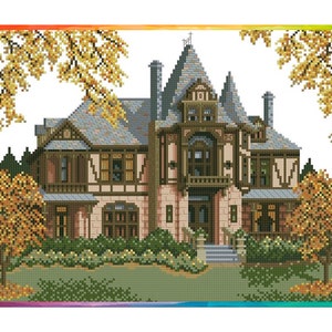 May include: A large, brown, Victorian-style house with a gray roof and many windows. The house is surrounded by trees with yellow leaves and a green lawn.