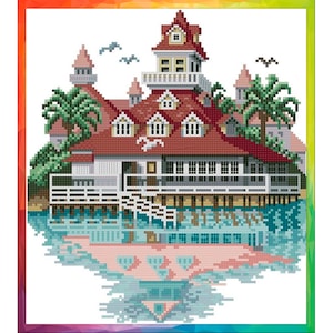 May include: A red and white building with a red roof and white trim sits on a pier over blue water. The building has a tower with a white railing and windows. Palm trees are on either side of the building. The building is reflected in the water.